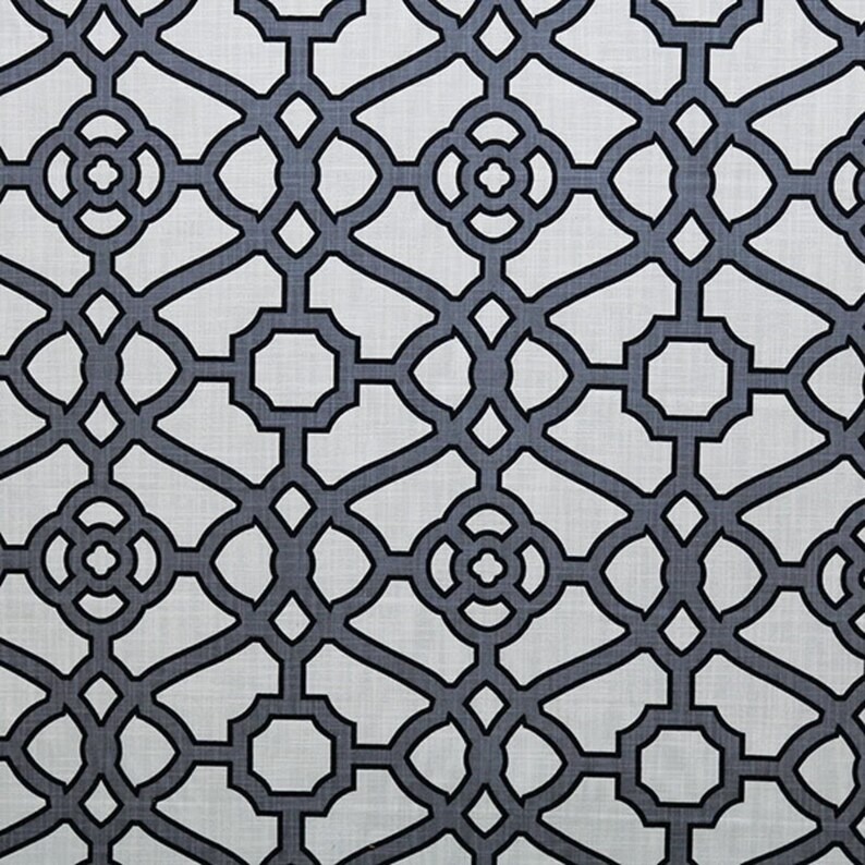 May include: A white fabric with a repeating geometric pattern of black interlocking circles and squares.