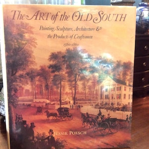 May include: A hardcover book titled The Art of the Old South: Painting, Sculpture, Architecture & the Products of Craftsmen 1560-1860 by Jessie Poesch. The cover features a historical painting of a horse-drawn carriage scene near a large house.