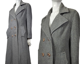 May include: A long gray wool coat with a double breasted closure and large buttons. The coat has a classic style with a pointed collar and flap pockets.