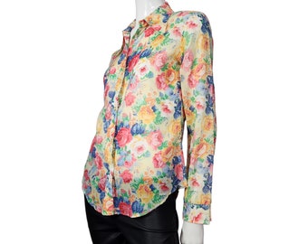May include: A yellow, pink, blue, and green floral print long-sleeve button-up shirt.