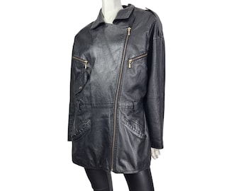 May include: A black leather jacket with a long, asymmetrical zipper and gold hardware. The jacket has a stand-up collar and multiple pockets.