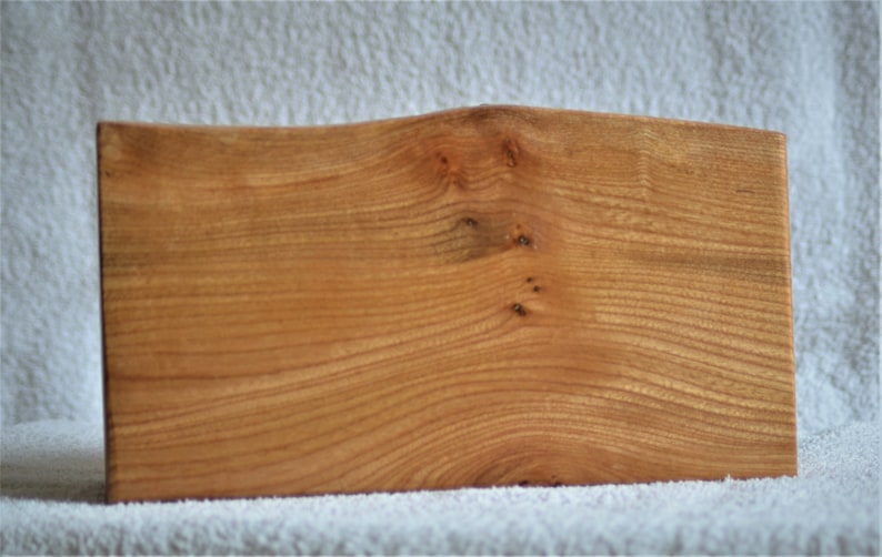 A Rustic three drawer boxchest cut from a solid Elm log with feature bark edge.
