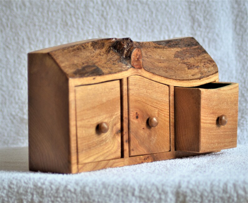 A Rustic three drawer boxchest cut from a solid Elm log with feature bark edge.