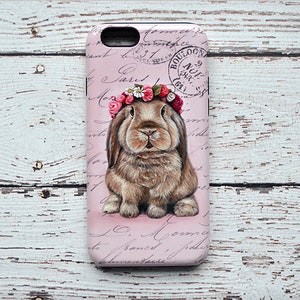 May include: A pink phone case featuring a detailed illustration of a brown rabbit wearing a floral crown. The case has a vintage aesthetic with script and a stamp that reads "BOULOGNE".