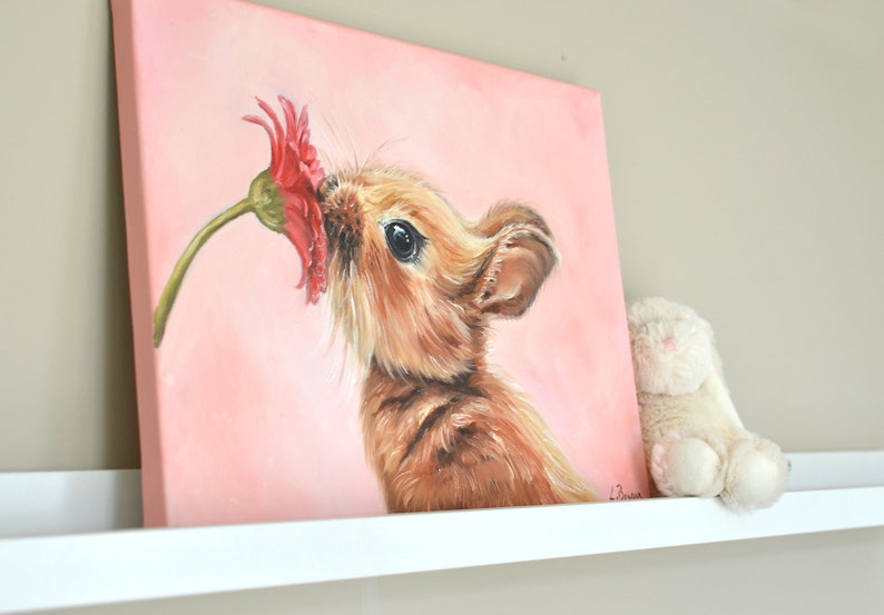 May include: A painting of a brown bunny rabbit sniffing a pink flower on a pink background.