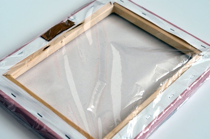May include: A wrapped canvas painting with a wooden frame and a pink backing. The canvas is wrapped around the frame and secured with staples. The painting is protected by a clear plastic wrap.