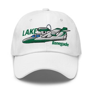 May include: White baseball cap featuring an embroidered design of a seaplane in green, white, and blue. The text "LAKE" and "Renegade" are above and below the plane. The cap has a curved brim and an adjustable strap.