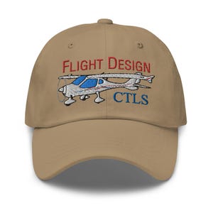 May include: A tan baseball cap with an embroidered design of a small airplane with the text "FLIGHT DESIGN" in red and "CTLS" in blue.