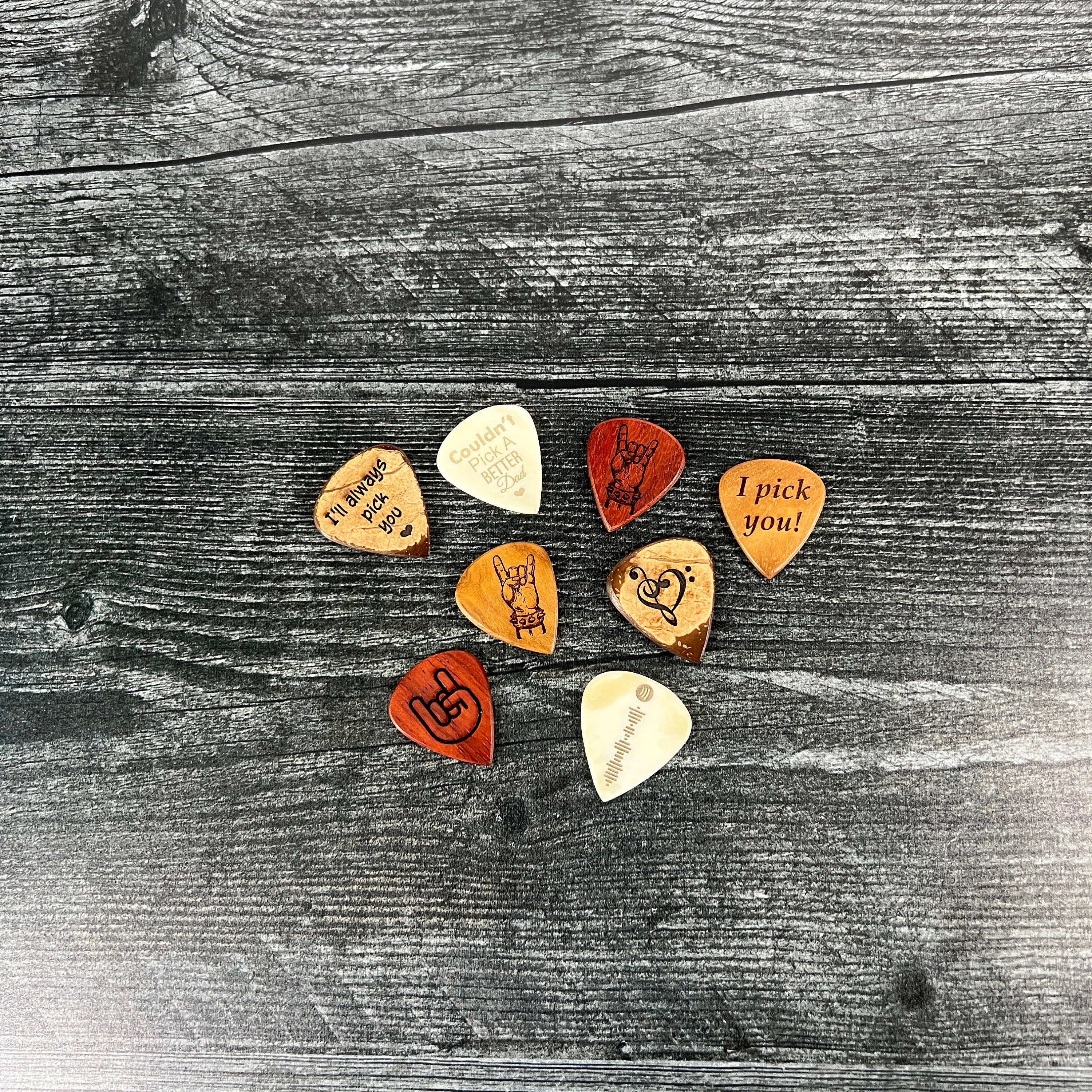 I listed that I have a massive Sharpie/Pen collection and that I'm learning  guitar, so my Secret Santa went and ordered me a handmade wooden  Sharpie/Pen organizer, AND a handmade leather guitar pick holder  embroidered with my initials. I am enthralled