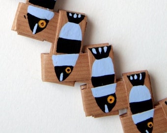 recycled paper necklace decorated with black and blue fishes