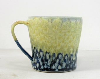 coffee cup in yellow and blue with polka dots