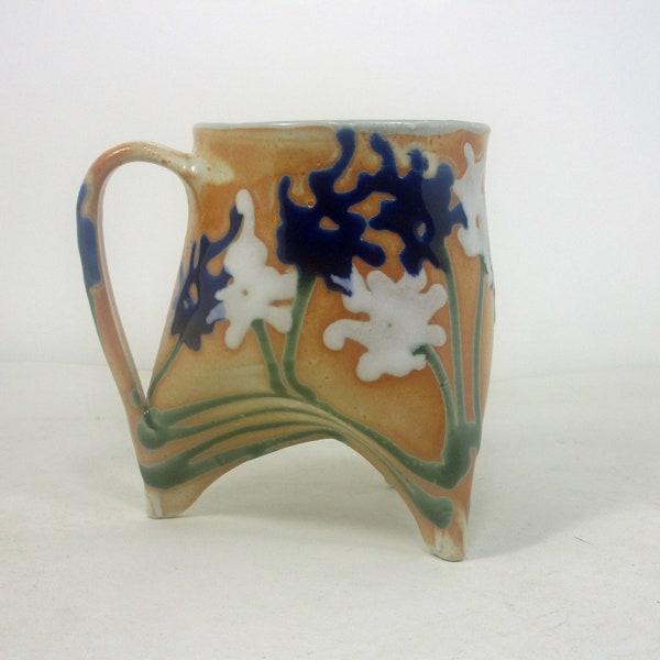 ceramic tripod coffee cup in shino with white and blue flowers