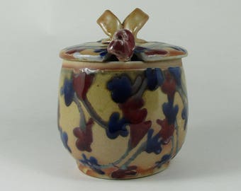 Shino honey jar with blue and red flowers