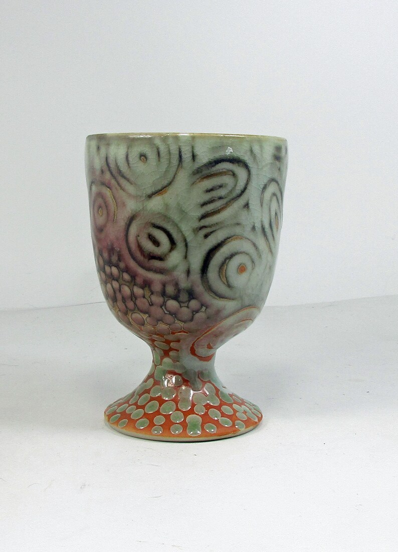 Ceramic wine glass in shino with white to red concentric ...