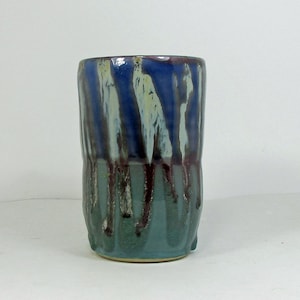 ceramic pint glass in green and blue with red and light blue lines