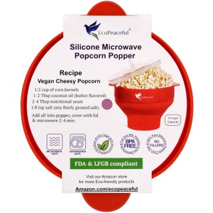 May include: Red silicone microwave popcorn popper with a white lid. The popper has a 14 cup capacity and is BPA free, dishwasher safe, and microwave safe. The packaging includes a recipe for vegan cheesy popcorn. The text on the packaging reads "EcoPeaceful Silicone Microwave Popcorn Popper" and "FDA & LFGB compliant".