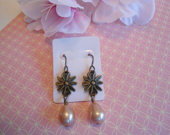 Pink daisy earrings:  Antique brass salmon pink daisy flower earrings with Vintaj brand earring hooks and head pins