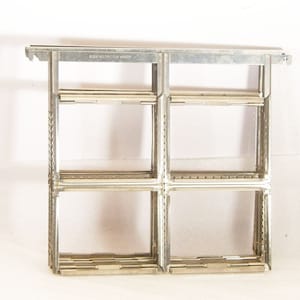 May include: A silver Kodak Multiple Film Hanger. The hanger features a rectangular grid design with multiple compartments for holding film. The text "KODAK MULTIPLE FILM HANGER" is printed on the top bar. Designed for photographic use.