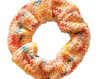 May include: A colorful knitted hair scrunchie in shades of orange, yellow, blue, and white.