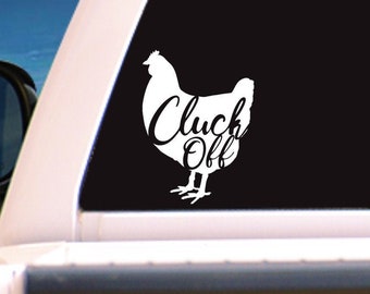 May include: White vinyl decal of a chicken with the text "Cluck Off" on a black truck tailgate.