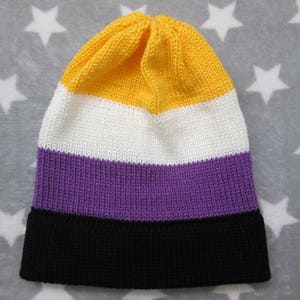 May include: A knitted beanie with yellow, white, purple, and black stripes.