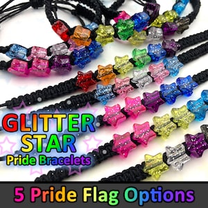 May include: Five black braided bracelets with rainbow glitter star beads. The bracelets are labelled "Glitter Star Pride Bracelets" and "5 Pride Flag Options".