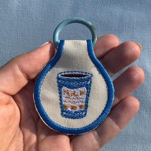Embroidered NYC Coffee Cup Keychain: Recycled Fabric & Ring