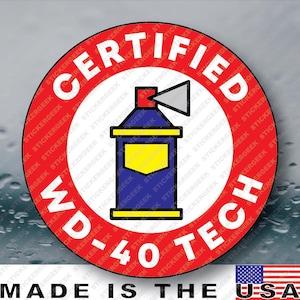 May include: A circular sticker featuring a red border with the white text CERTIFIED and WD-40 TECH. The center displays a blue spray can icon with a yellow label and a gray nozzle. The background of the sticker is white with a repeating watermark.
