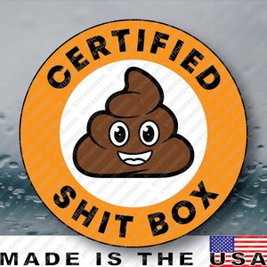 May include: A circular sticker with an orange border and a white center. The text CERTIFIED SHIT BOX is printed in black capital letters around the border. In the center is a brown cartoon poop emoji with large white eyes and a smiling mouth.