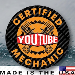 May include: A circular sticker featuring a black background with the orange text CERTIFIED YOUTUBE MECHANIC arranged in a circle. The center displays two crossed engine pistons in orange over a gear icon, with the word YOUTUBE in white on a red banner.