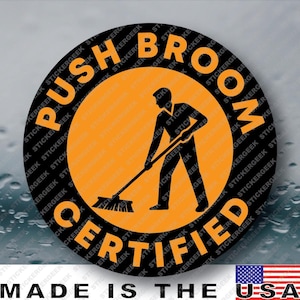 May include: A circular sticker featuring a black silhouette of a person using a push broom in the center against an orange background. The text PUSH BROOM CERTIFIED is printed in bold orange capital letters along the black circular border.