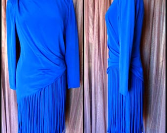 May include: A royal blue dress with long sleeves and a fringe skirt.