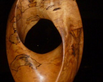 Large Mobius Strip. Oval Eye, hand carved vertically mounted mobius on steel base