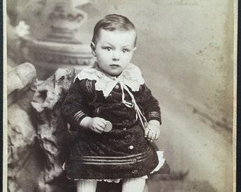 Photo of Cute Little BOY Wearing a DRESS and Holding a Cookie, Bisquit, or Token?? - Studio Props - Bowling Green, Ohio