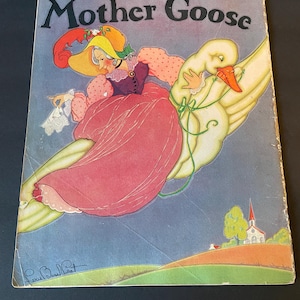 May include: Vintage "Mother Goose" book cover illustration. A woman in a pink dress and yellow hat rides a goose across a blue sky. The cover features the title "Mother Goose" in black letters.