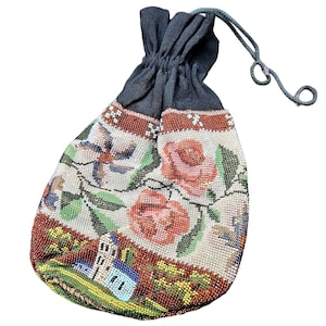 May include: A drawstring pouch featuring intricate beadwork in a landscape design with pink roses, green foliage, and a small building. The upper section is made of solid black fabric with a matching drawstring cord for closure and carrying.