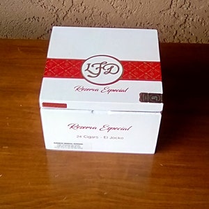 May include: A white box with a red and gold label that says "LF&D Reserva Especial" and "24 Cigars - El Jocko".
