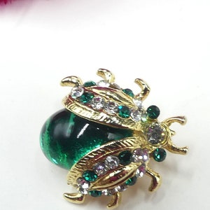 Vintage gold tone green rhinestone green glass cabochon ladybug pin brooch