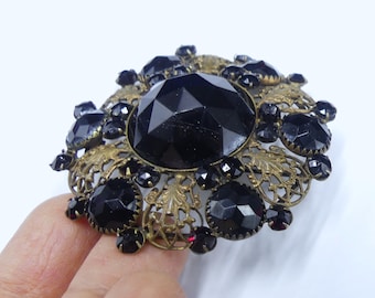 Antique large 1900's brass tone & faceted red black glass round pin brooch