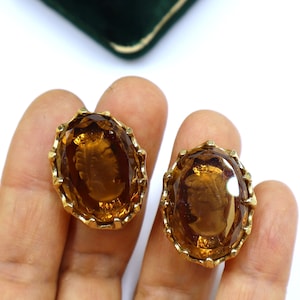 Vintage gold tone Cameo reverse carved oval shape amber glass clip on earrings