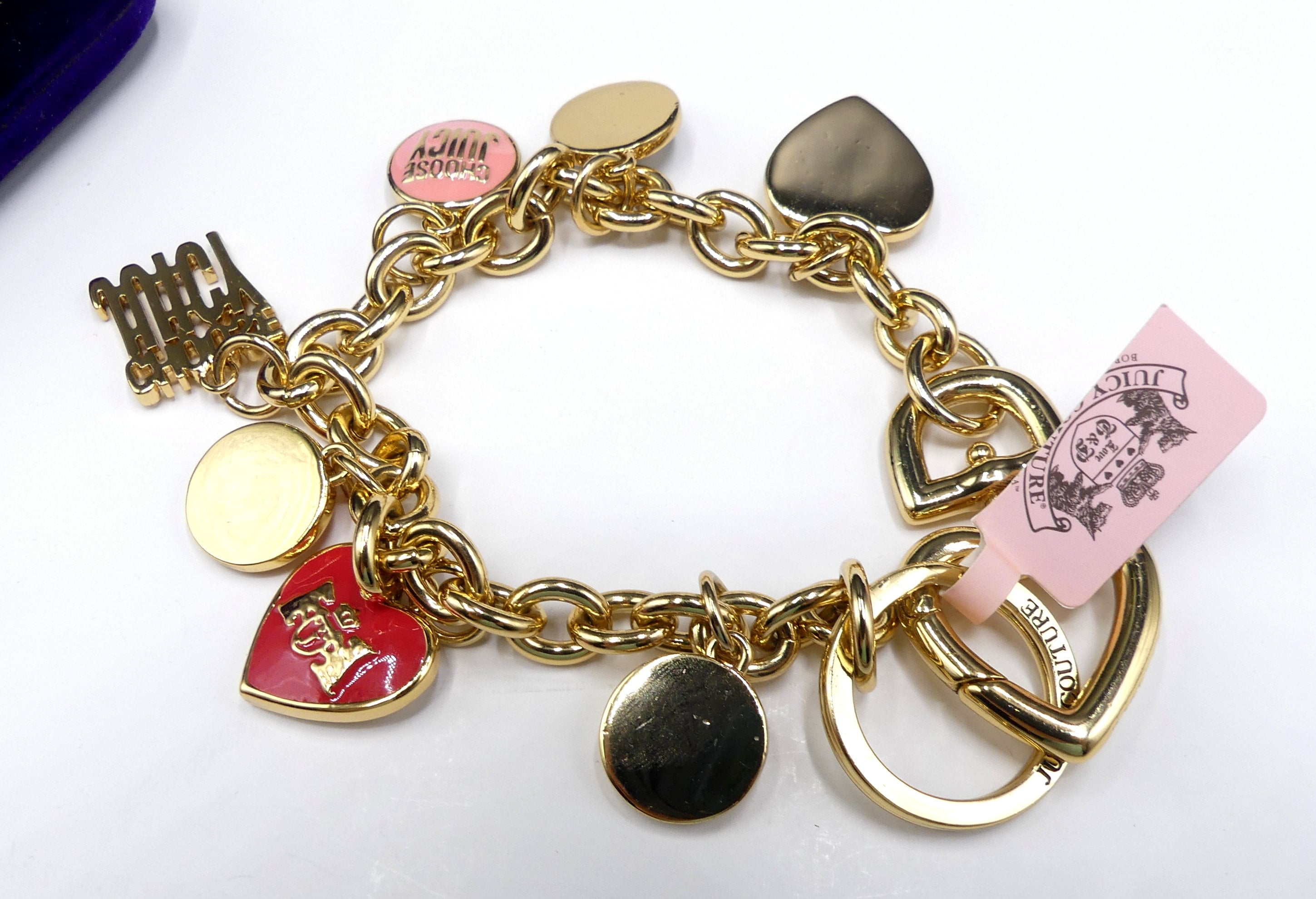 Brand new signed Juicy Couture gold tone & enamel multi charms bracelet w  tag