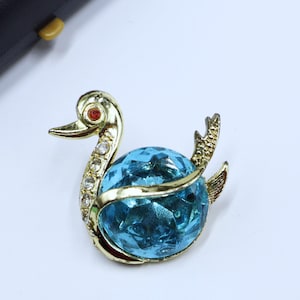 Vintage gold tone & blue glass duck pin brooch