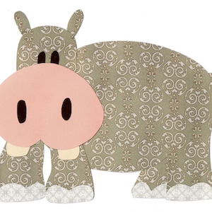 May include: A light brown and pink felt hippopotamus with a patterned design. The hippopotamus has a large pink nose and small black eyes.