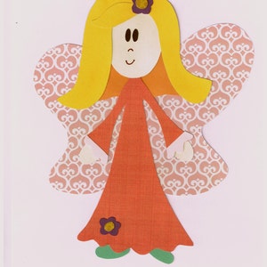 May include: A paper craft angel with blonde hair, a red dress, and pink wings with a white pattern. The angel has a flower on its head and a flower on its dress.