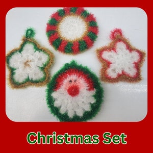 May include: Set of four crocheted Christmas ornaments. The ornaments are shaped like a wreath, a star, a snowflake, and a Santa Claus face. The ornaments are white with red, green, and gold accents.