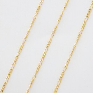 May include: Three gold chains of different lengths and widths. The chains are made of a delicate, fine-link design.