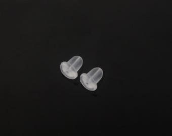 May include: Two clear plastic earring backs. The backs are shaped like a small cone with a flat base.