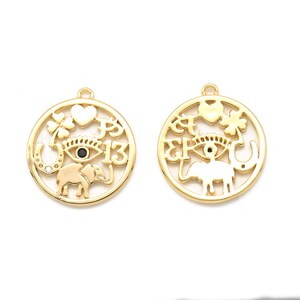 May include: Two gold-colored round pendants with various cut-out designs. Each pendant features an eye, elephant, horseshoe, heart, and four-leaf clover. One pendant has the number 13. The pendants have a small loop at the top for hanging.