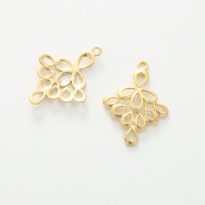 May include: Two gold-colored metal pendant charms with a delicate, intricate design resembling a cluster of small teardrop shapes. The charms have a loop at the top for attaching to jewelry.