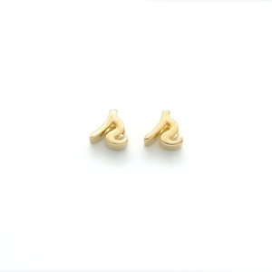 May include: A pair of gold-toned earrings with a stylized letter 'S' design.
